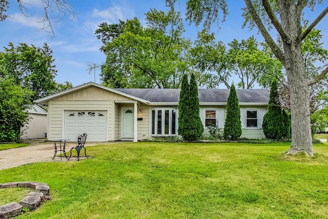 ranch-style home featuring a garage and a front lawn