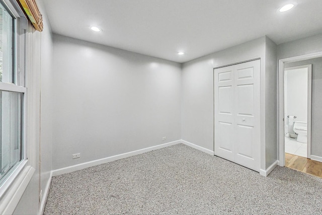 unfurnished bedroom featuring a closet and carpet floors