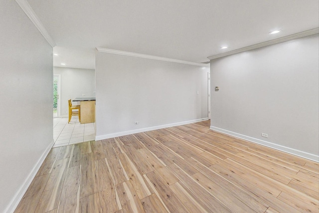 unfurnished room featuring light wood-type flooring and crown molding