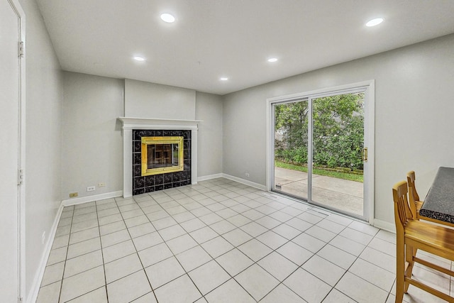 unfurnished living room featuring light tile patterned floors and a tile fireplace