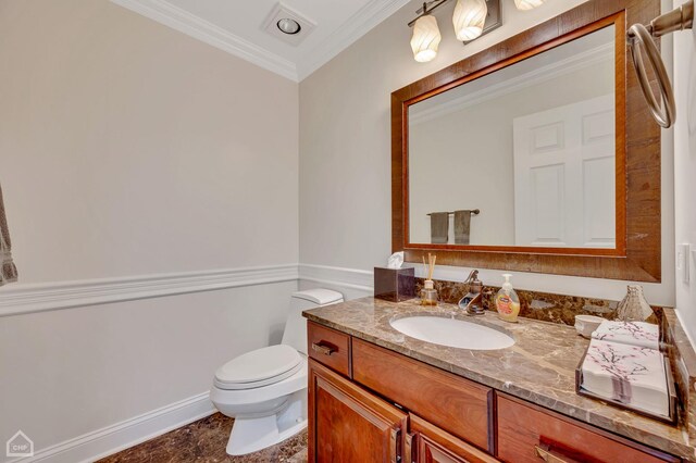 bathroom featuring toilet, crown molding, and vanity