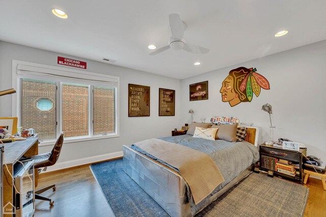 bedroom with wood-type flooring and ceiling fan