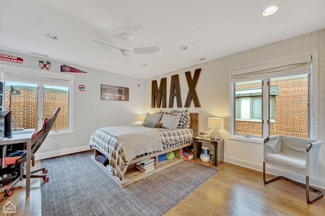 bedroom with ceiling fan and light hardwood / wood-style flooring