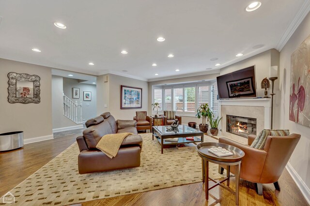 living room with crown molding and hardwood / wood-style floors