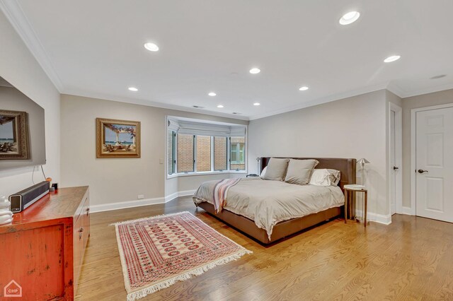 bedroom featuring ornamental molding and light hardwood / wood-style floors