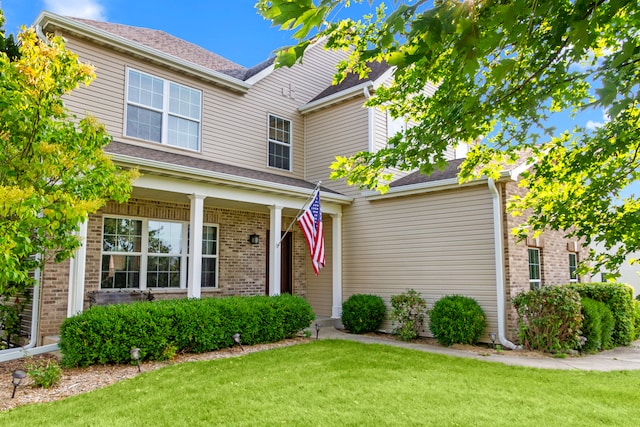 view of front of property with a front yard and a porch