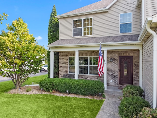 view of front of home featuring a porch and a front yard