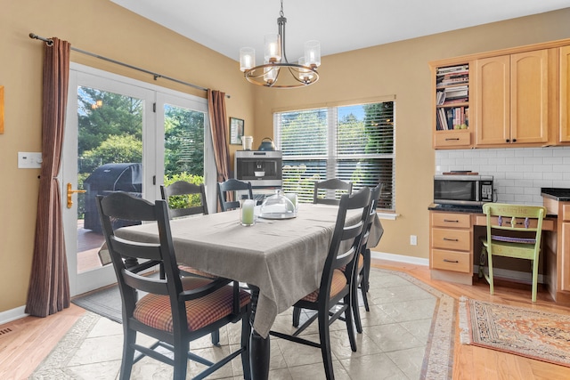 dining room featuring light hardwood / wood-style floors, a chandelier, and a healthy amount of sunlight