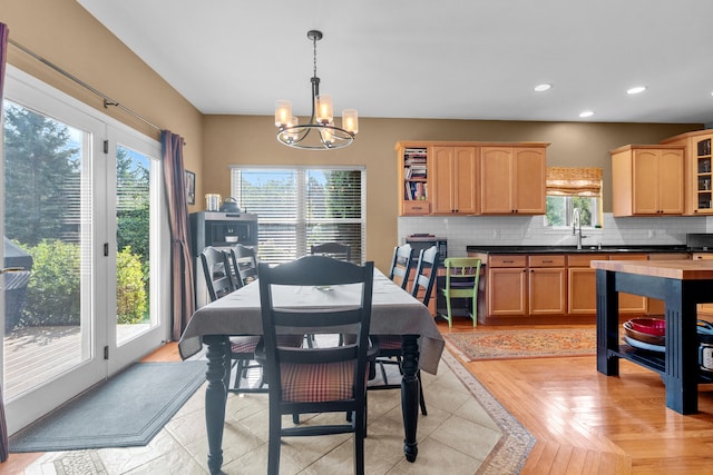 dining room featuring sink and an inviting chandelier