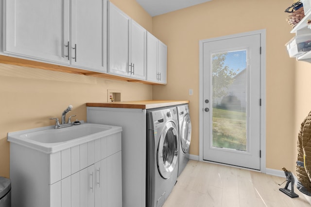 laundry room with cabinets and washing machine and dryer