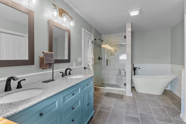 bathroom featuring vanity, tile patterned floors, independent shower and bath, and tile walls