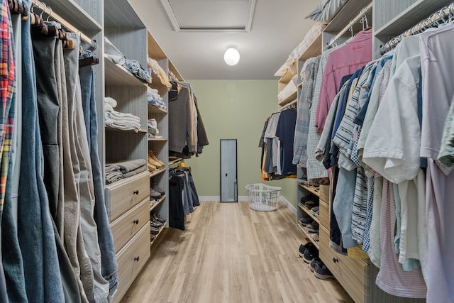 walk in closet featuring light hardwood / wood-style flooring