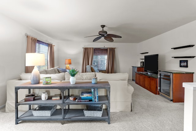 carpeted living room featuring beverage cooler and ceiling fan