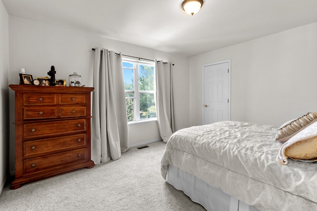 bedroom featuring light colored carpet