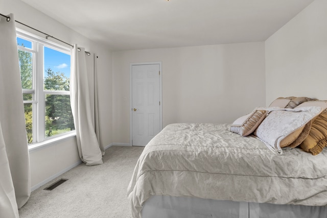 bedroom featuring light carpet