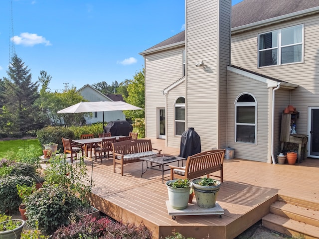 deck featuring area for grilling and outdoor lounge area