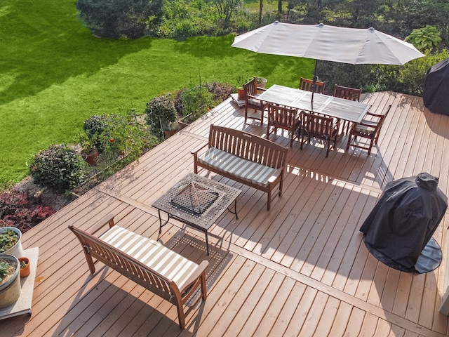 wooden deck with a lawn