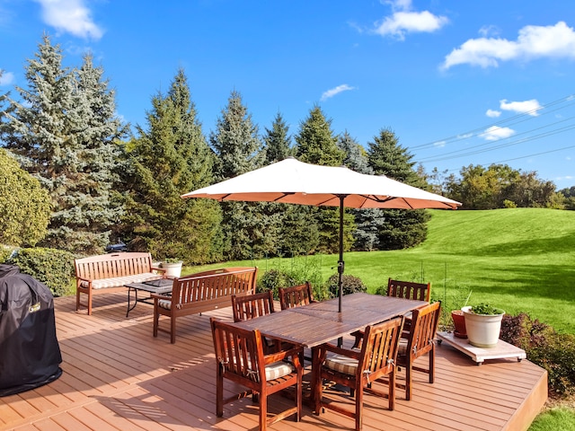 wooden deck featuring area for grilling and a yard