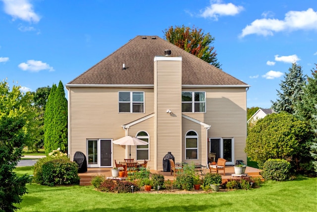 back of property with a lawn and a patio area