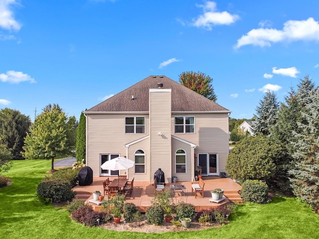 rear view of house with a lawn and a patio