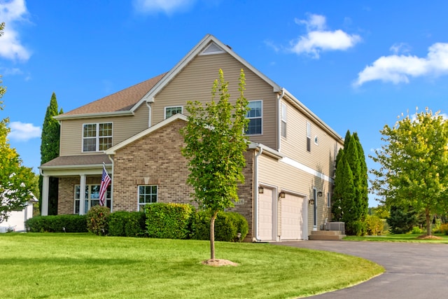 view of front of property with a garage and a front lawn