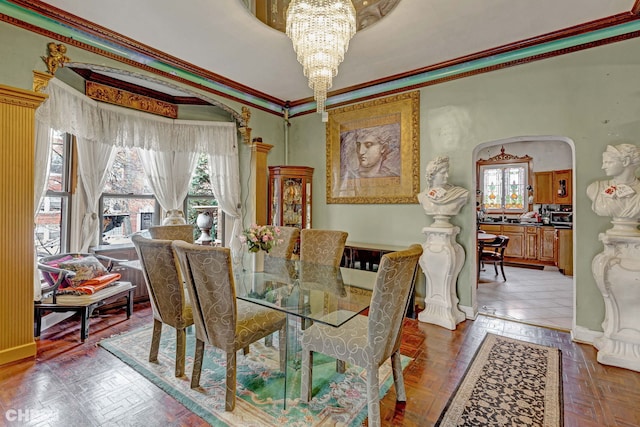 dining area featuring crown molding, parquet flooring, and a chandelier