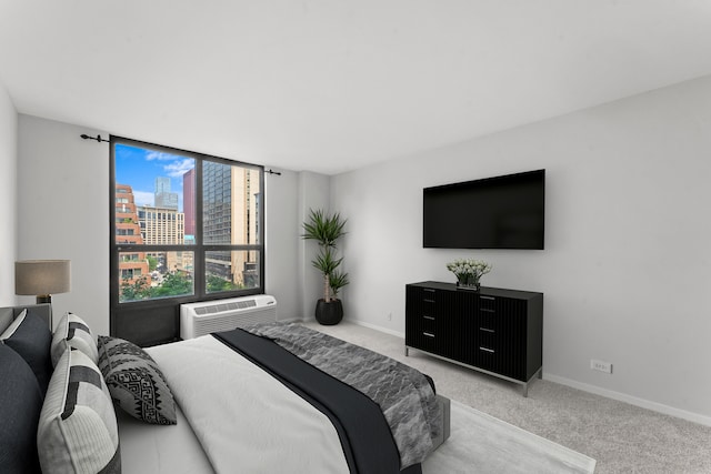 carpeted bedroom with an AC wall unit