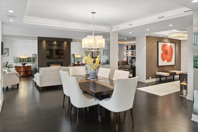 1040 N Lake Shore Dr Unit 9A, Chicago, IL 60611 - dining room with dark wood-style flooring, recessed lighting, a raised ceiling, and a large fireplace