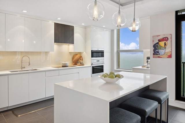 1040 N Lake Shore Dr Unit 9A, Chicago, IL 60611 - kitchen featuring a sink, modern cabinets, white double oven, dark tile patterned flooring, and white cabinets