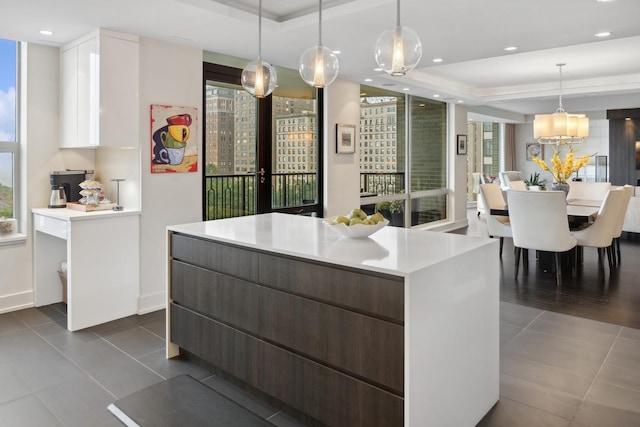 1040 N Lake Shore Dr Unit 9A, Chicago, IL 60611 - kitchen featuring a tray ceiling, dark tile patterned floors, a kitchen island, light countertops, and recessed lighting