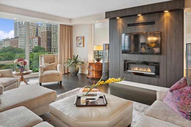 1040 N Lake Shore Dr Unit 9A, Chicago, IL 60611 - living room featuring a large fireplace, wood finished floors, baseboards, a city view, and floor to ceiling windows