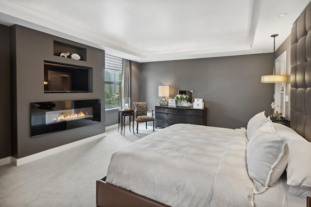 1040 N Lake Shore Dr Unit 9A, Chicago, IL 60611 - carpeted bedroom featuring a glass covered fireplace, a tray ceiling, and baseboards