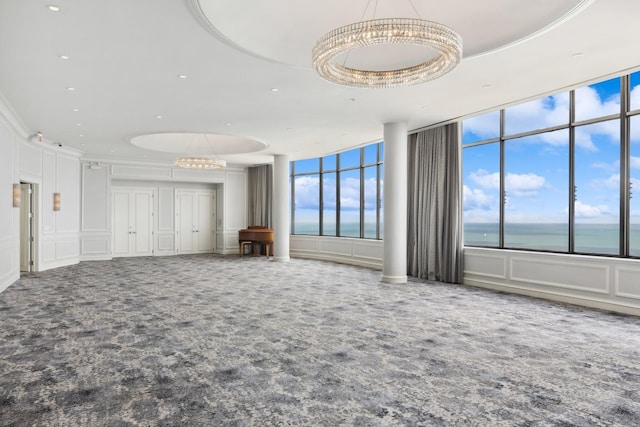 1040 N Lake Shore Dr Unit 9A, Chicago, IL 60611 - carpeted empty room featuring a chandelier, a water view, and a decorative wall