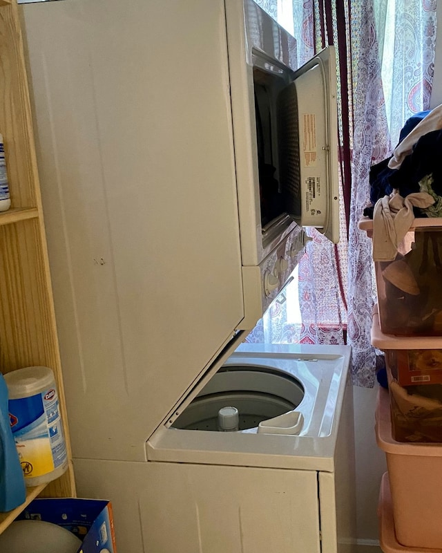 laundry room with stacked washing maching and dryer