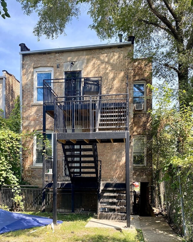 back of property with a deck and cooling unit