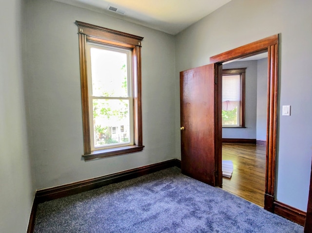 empty room with hardwood / wood-style flooring