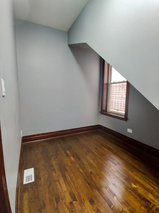 bonus room with dark hardwood / wood-style flooring