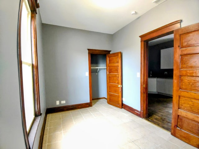 unfurnished bedroom featuring a closet and light wood-type flooring