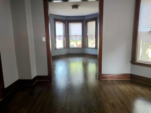 empty room with dark hardwood / wood-style floors