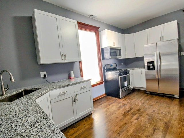 kitchen with white cabinets, stainless steel appliances, a wealth of natural light, and sink