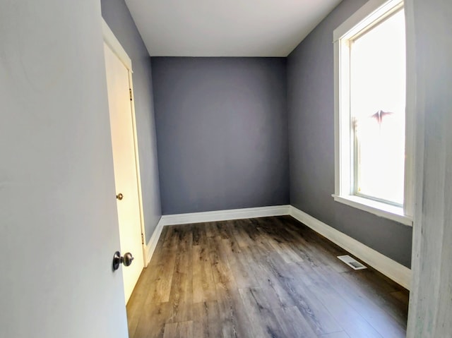 spare room with wood-type flooring