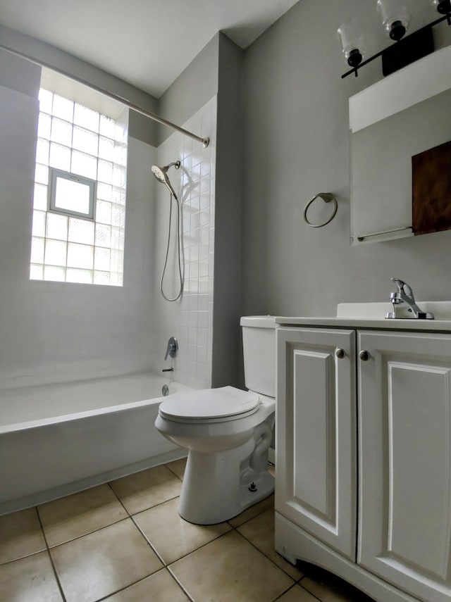 full bathroom featuring tile patterned flooring, vanity, tiled shower / bath combo, and toilet