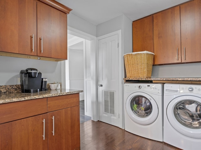 washroom featuring separate washer and dryer, cabinets, and dark hardwood / wood-style floors