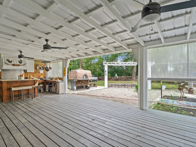 deck with a pergola, a bar, and ceiling fan