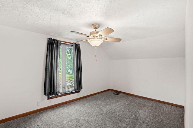 bonus room with lofted ceiling, a textured ceiling, ceiling fan, and carpet