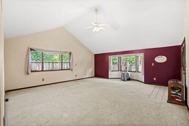 unfurnished living room featuring light colored carpet, ceiling fan, and high vaulted ceiling