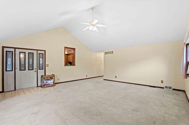 interior space featuring light colored carpet, ceiling fan, and high vaulted ceiling