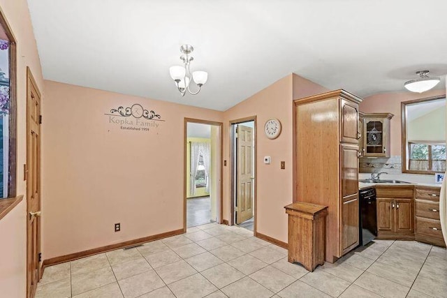 kitchen featuring a notable chandelier, sink, black dishwasher, light tile patterned flooring, and tasteful backsplash