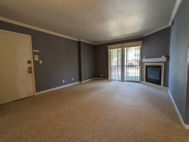 unfurnished living room with carpet, baseboards, crown molding, and a glass covered fireplace