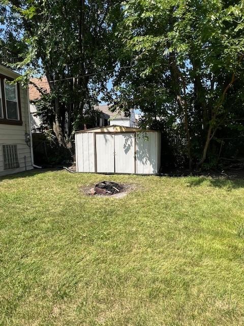 view of yard featuring an outbuilding and a storage shed